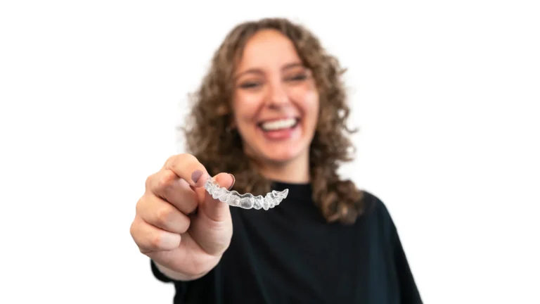 Woman holding clear aligners